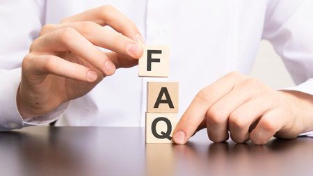 faq, frequency asked questions text on cube blocks in businessman hands, white backgroundの写真素材