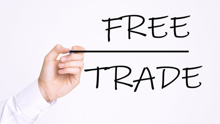 Businessman writing FREE TRADE with marker on transparent board. Business, internet, technology concept.の写真素材