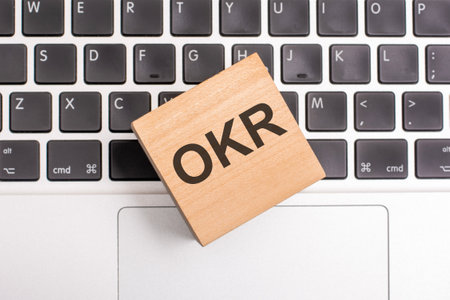 OKR inscription concept on wooden block on keyboardの写真素材
