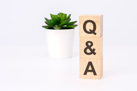text Q and A on wooden blocks in white background with copy space. business concept.の写真素材