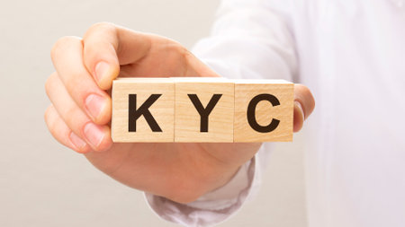 wooden cubes with the letters KYC on the hand on the white backgroundの写真素材