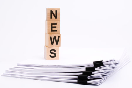 wooden cubes with text NEWS on white tableの写真素材