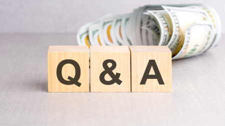 word question and answer on wooden cubes, gray background, business conceptの写真素材
