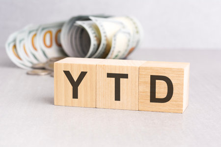 word YTD on wooden cubes, gray background, business conceptの写真素材