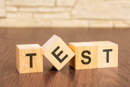 wooden blocks with word TEST on brown background. frequently asked question conceptの写真素材