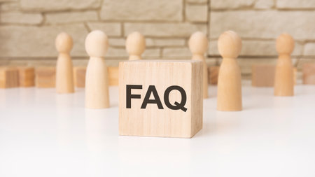 FAQ - wooden cubes with letters, Frequency Asked Questions concept, front view on gray backgroundの写真素材