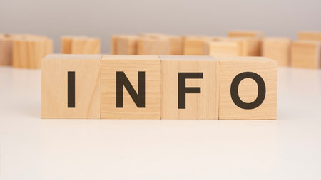 short word english letters with text - INFO - on a small wooden cubes with white background. copy space concept. selection focus.の写真素材