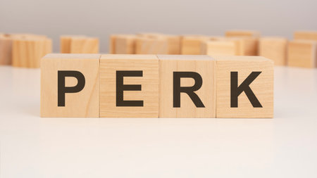 short word english letters with text - PERK - on a small wooden cubes with white background. copy space concept. selection focusの写真素材