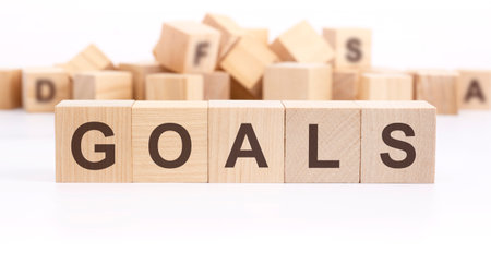 wooden cube with text GOALS on white background. Goals business and New Year conceptsの写真素材
