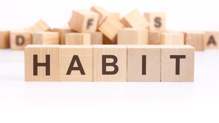 wooden cube with text HABIT on white background. Goals business and New Year conceptsの写真素材