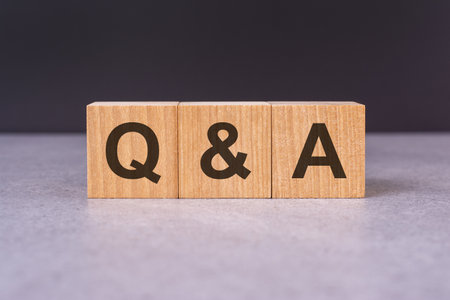 concept word Q and A on cubes on a beautiful grey background. business concept, copy spaceの写真素材