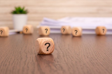 curiosity concept with a question mark block standing on a wooden backgroundの写真素材