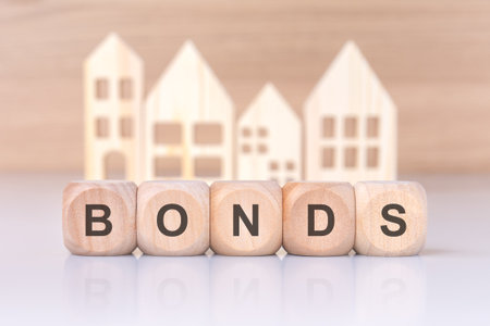 wooden blocks spelling 'BONDS' with house cutouts, representing property deals and real estate opportunitiesの写真素材
