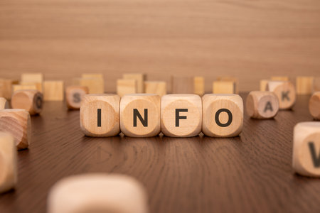 he image of four wooden cubes with the text 'INFO' on a light brown background. conveys a business concept focused on the dissemination and accessibility of essential informationの写真素材