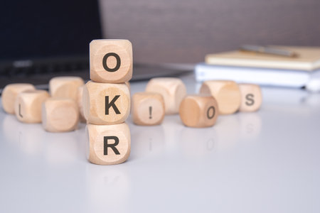 wooden blocks with OKR letters symbolize the concept of Objectives and Key Results, a framework for setting and achieving goals within an organization.の写真素材