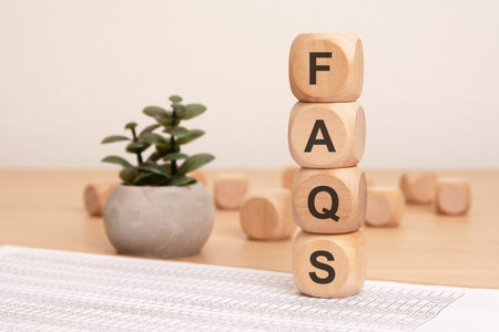 A modern FAQ display with stylish wooden blocks and a plant small to enhance ambiance and create a calming effectの写真素材