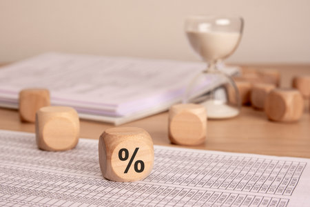 Delve into the world of financial metrics and comprehensive analysis using wooden blocks and various documentsの写真素材