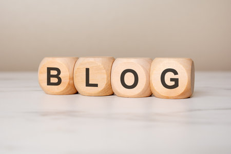 Close-up of wooden blocks with word BLOG, representing blogging, content creation, digital media,...