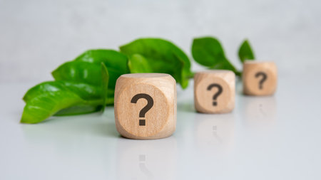 wooden blocks printed with sign question placed in a row on a neutral surface. symbolizes inquiry,...