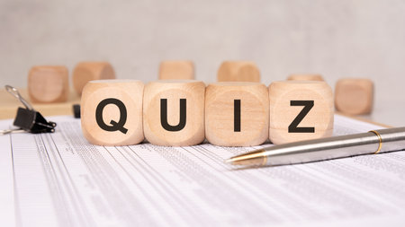 Wooden blocks with the word QUIZ on office desk, concept of test or knowledge checkの写真素材