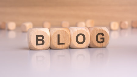 wooden cubes spelling BLOG on a clean table, symbolizing content creation and bloggingの写真素材
