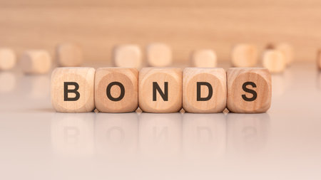 the text BONDS is written on wooden cubes on a brown backgroundの写真素材