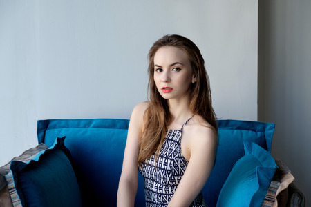 beautiful girl sitting on a couchの写真素材