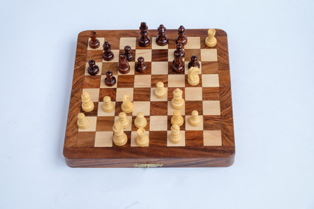 Chessboard with figures in progress isolated