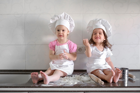 happy family funny kids are preparing the dough, bake cookies in the kitchenの写真素材