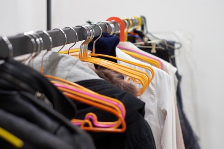 Clothes rack with different clothes in the dressing room