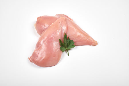 Raw chicken breast fillets isolated on white backgroundの写真素材