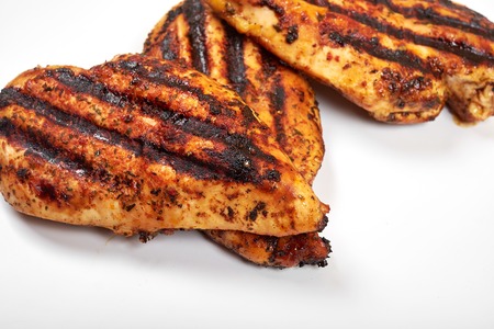 Chicken meat. Grilled fillet pieces isolated on white background.の写真素材