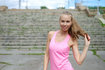 woman doing stretching exercise in parkの写真素材