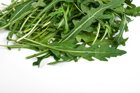green fresh ruccola isolated on white background, close up studio shotの写真素材