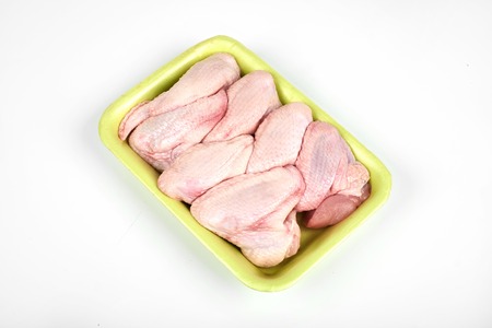 raw chicken wings package isolated on white backgroundの写真素材