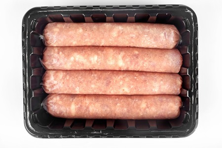 Package of raw sausages isolated on white background.の写真素材