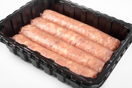 Package of raw sausages isolated on white background.の写真素材