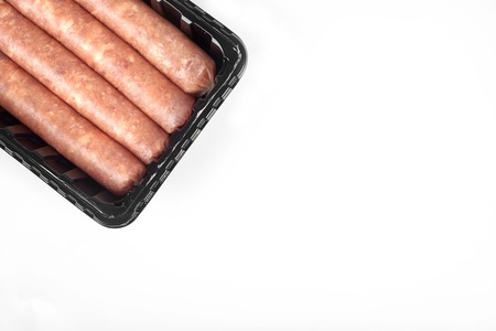 Package of raw sausages isolated on white background.の写真素材