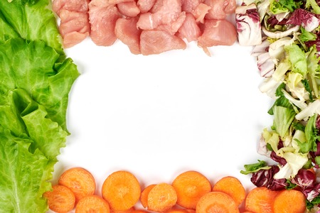 Frame of fresh vegetables and dietary meat isolated on the white background. Healthy natural food with copy space . Cooking ingredients top view, mockup for recipe or menu.の写真素材