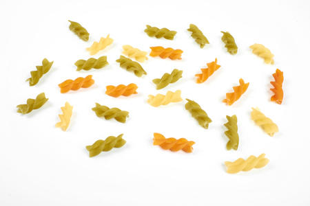 Raw colorful italian fusilli pasta isolated on white.