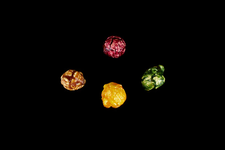 multicolored caramel popcorn on a black background