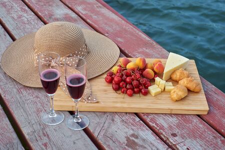 Two glasses of red wine, served outdoor with fruits