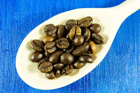 Coffee beans in wooden spoonの写真素材