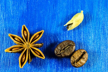 Star anise with coffee beans and kardamon on wooden backgroundの写真素材
