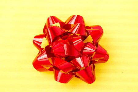 Red bow on yellow backgroundの写真素材