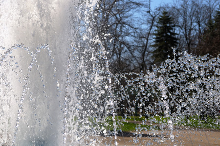 Sparkling splashes fountain in the bright sunny spring dayの写真素材