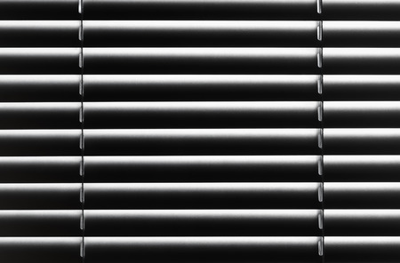 Abstract background closed blinds with strips of reflected lightの写真素材