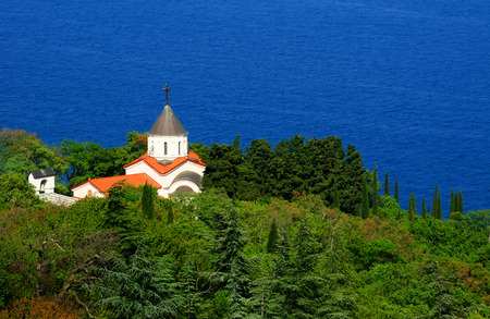 Beautiful summer landscape - the church Covers of the Blessed Virgin surrounded by lush green...