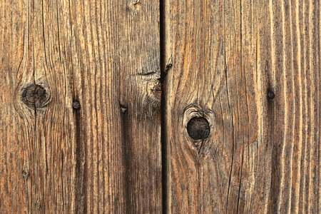 Wooden texture - darkened old cracked board nailed rusty nailsの写真素材