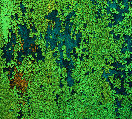Bizarre texture - old paint green and blue colors on a wooden surface, severely flakingの写真素材